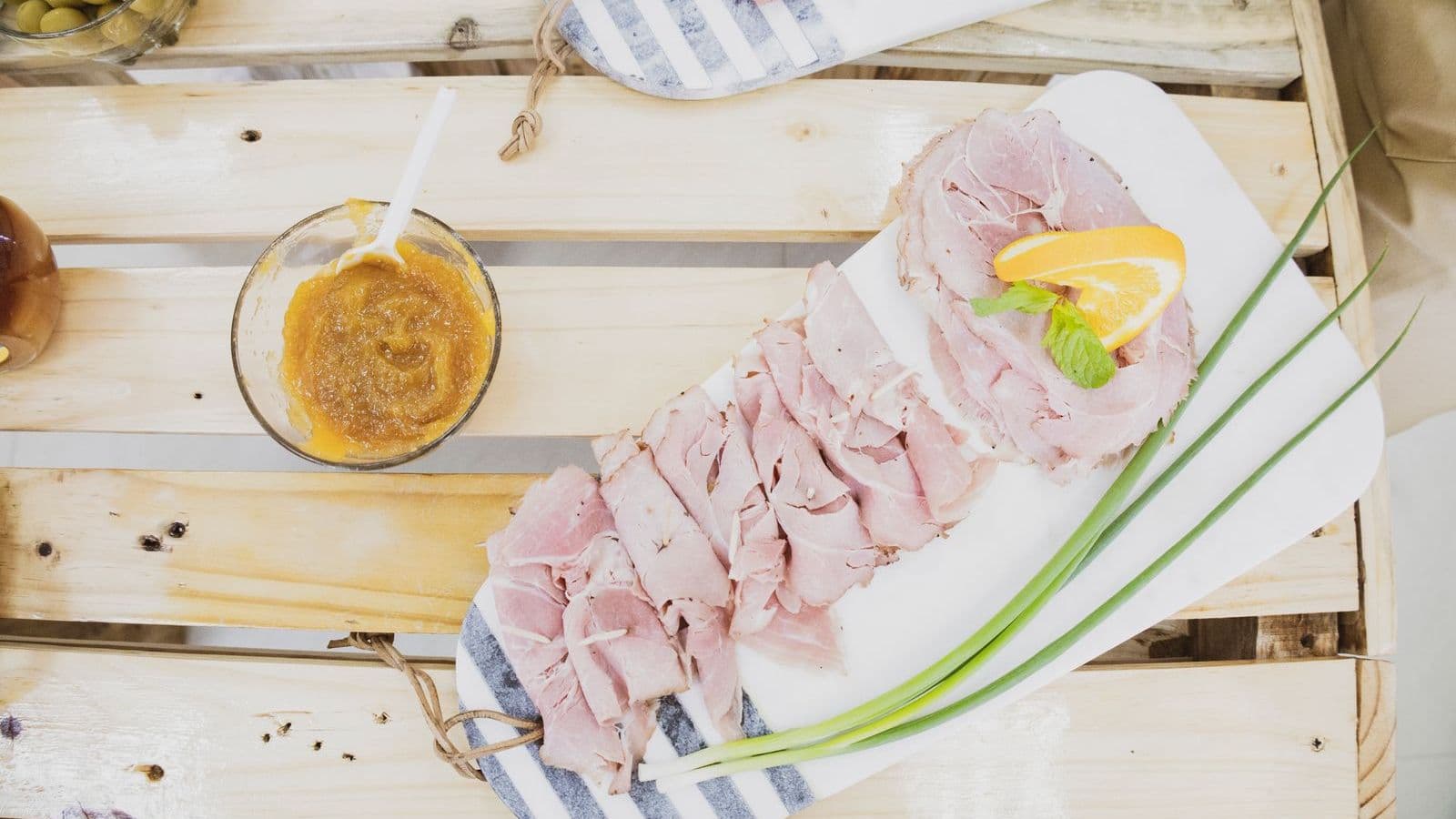 Sliced ham on a wooden board - Can Dogs Eat Ham? Salt, Fat and Glazes